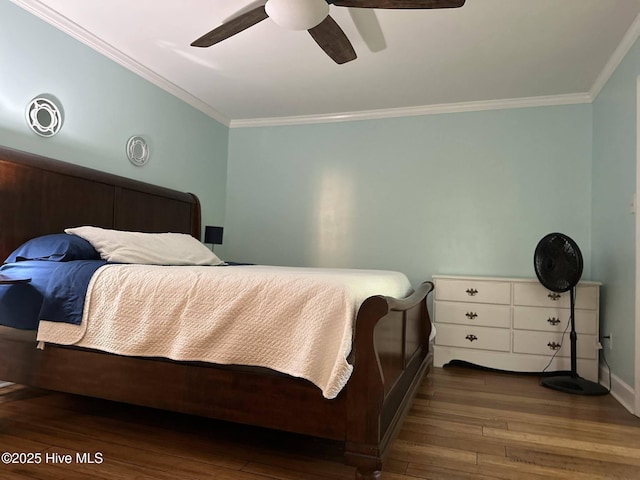 bedroom with dark hardwood / wood-style flooring, ceiling fan, and ornamental molding