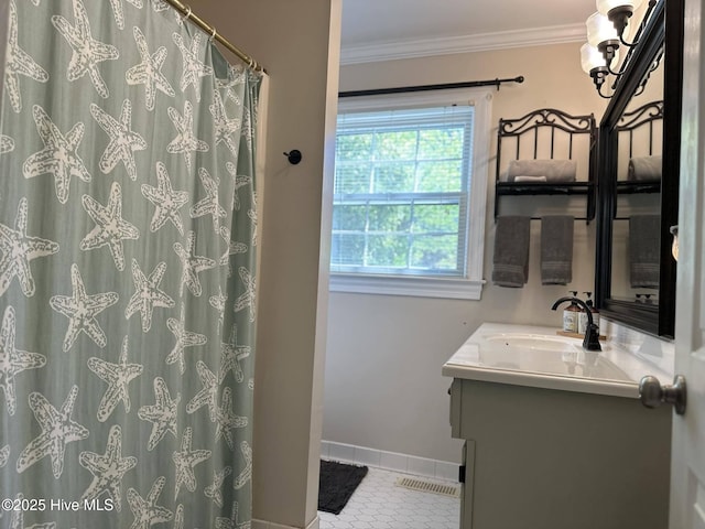 bathroom with tile patterned floors, vanity, and ornamental molding