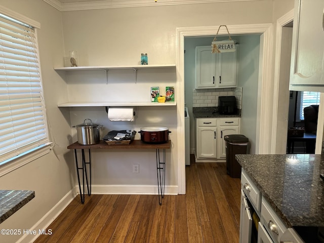 kitchen featuring a wealth of natural light, white cabinetry, dark wood-type flooring, backsplash, and crown molding