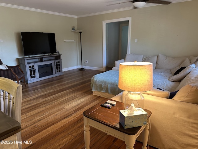 living room featuring ceiling fan, ornamental molding, and hardwood / wood-style flooring