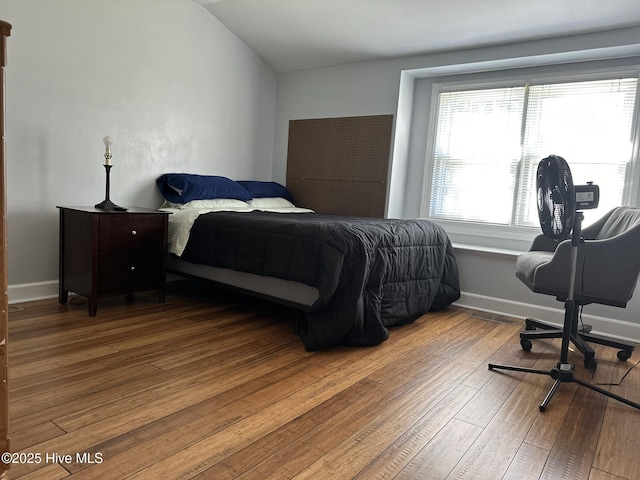 bedroom featuring wood-type flooring and lofted ceiling