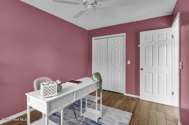 home office with ceiling fan and hardwood / wood-style floors