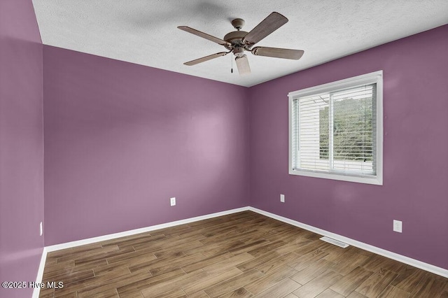 unfurnished room with hardwood / wood-style flooring, a textured ceiling, and ceiling fan