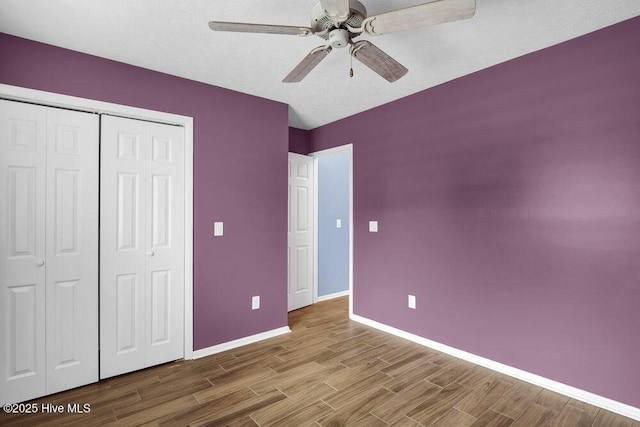 unfurnished bedroom with a closet and ceiling fan