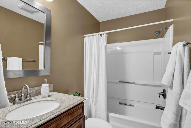 full bathroom with toilet, a textured ceiling, shower / tub combo with curtain, and vanity