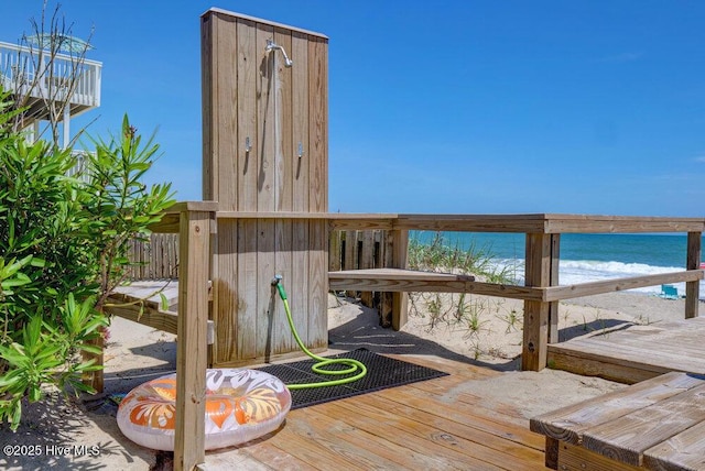 deck with a water view and a view of the beach