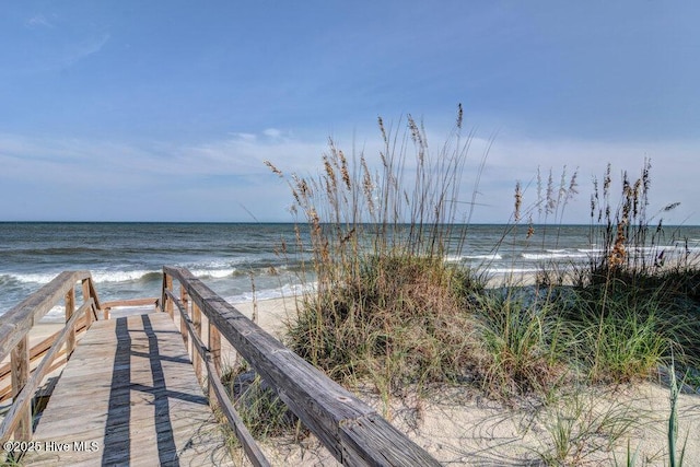 view of home's community with a beach view and a water view