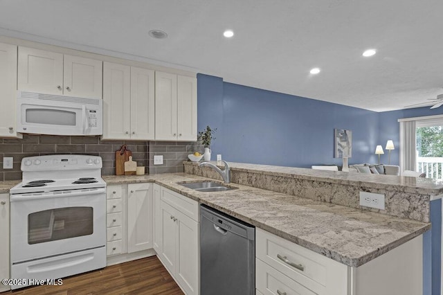 kitchen featuring sink, white cabinets, white appliances, and kitchen peninsula