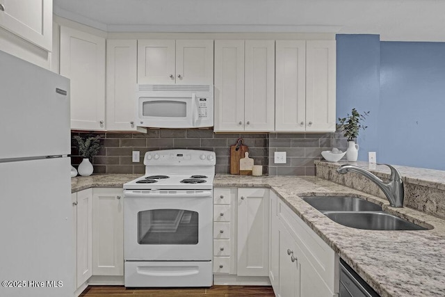 kitchen with sink, white appliances, tasteful backsplash, and white cabinets