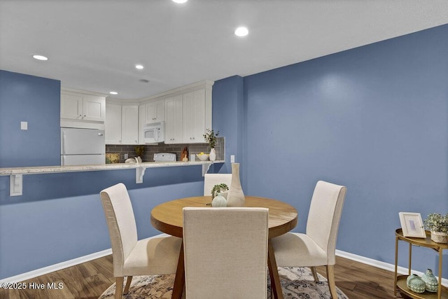 dining space featuring dark hardwood / wood-style floors