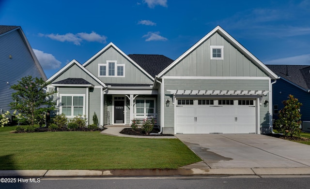 craftsman-style house featuring a garage and a front lawn