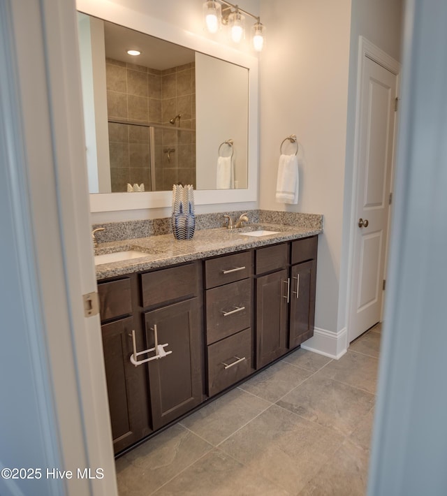 bathroom with tile patterned floors, vanity, and walk in shower