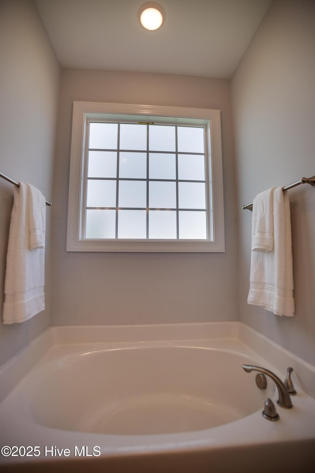 bathroom with plenty of natural light and a bathtub