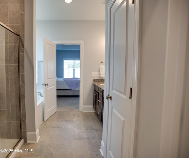 bathroom with vanity, tile patterned floors, and a shower with shower door