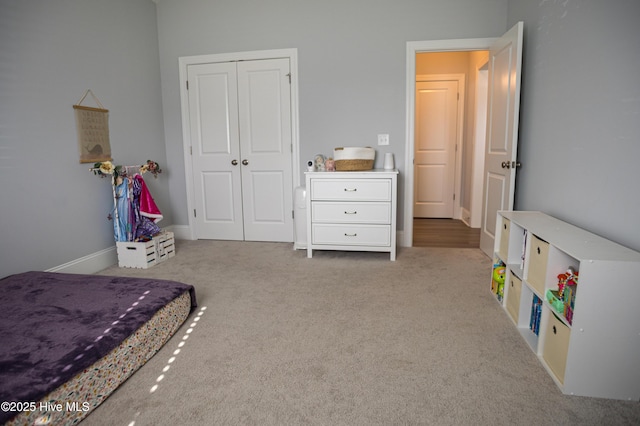 bedroom featuring light carpet and a closet