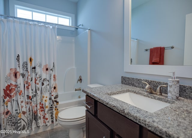 full bathroom with shower / bath combo, vanity, toilet, and tile patterned floors