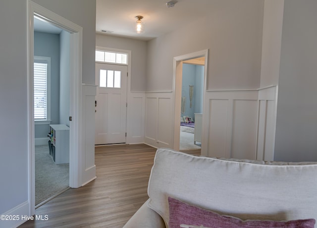 entrance foyer with a healthy amount of sunlight and light hardwood / wood-style floors