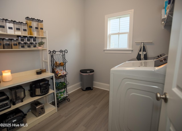 laundry room featuring separate washer and dryer and hardwood / wood-style flooring