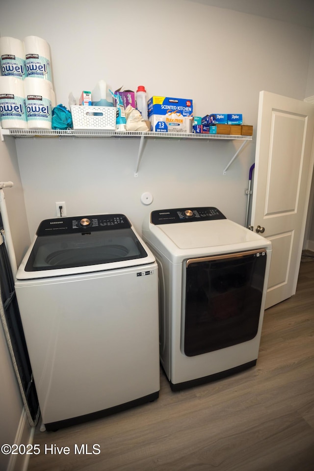 clothes washing area featuring dark hardwood / wood-style flooring and separate washer and dryer