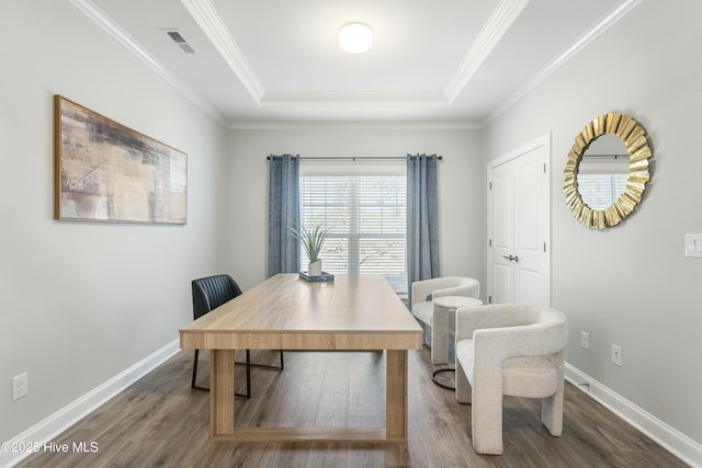 office area with baseboards, visible vents, and wood finished floors