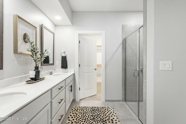 unfurnished bedroom featuring a walk in closet, light colored carpet, ensuite bath, and a closet