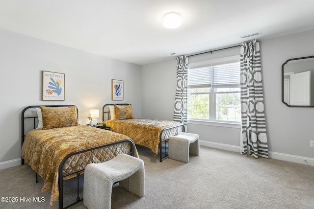 bedroom featuring baseboards, visible vents, and carpet