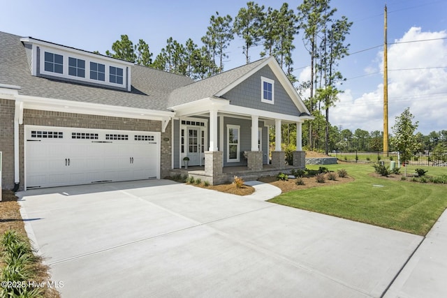 view of front of property featuring fence, an attached garage, concrete driveway, a front yard, and a porch