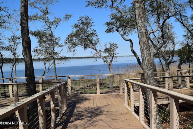 view of property's community featuring a deck with water view