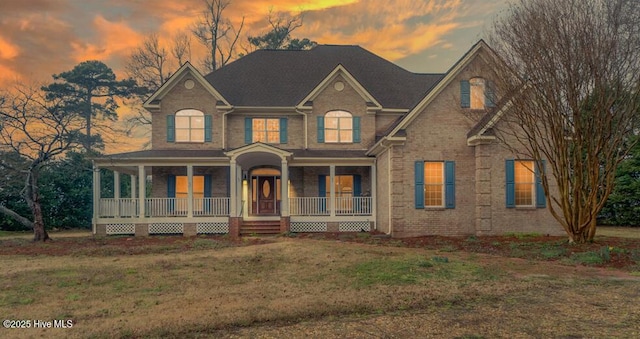 view of front of house with a yard and covered porch