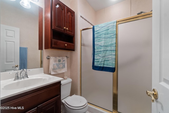 bathroom featuring vanity, toilet, and walk in shower