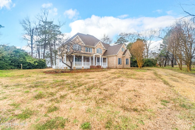 view of front of house with a porch and a front yard