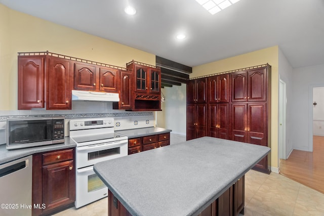 kitchen featuring appliances with stainless steel finishes, backsplash, and a kitchen island