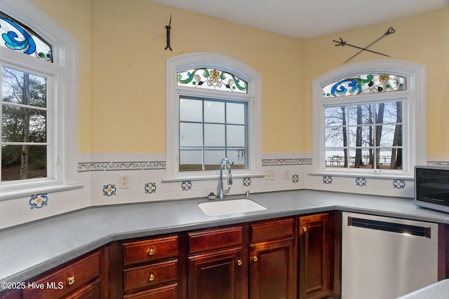 kitchen featuring a healthy amount of sunlight, sink, and appliances with stainless steel finishes