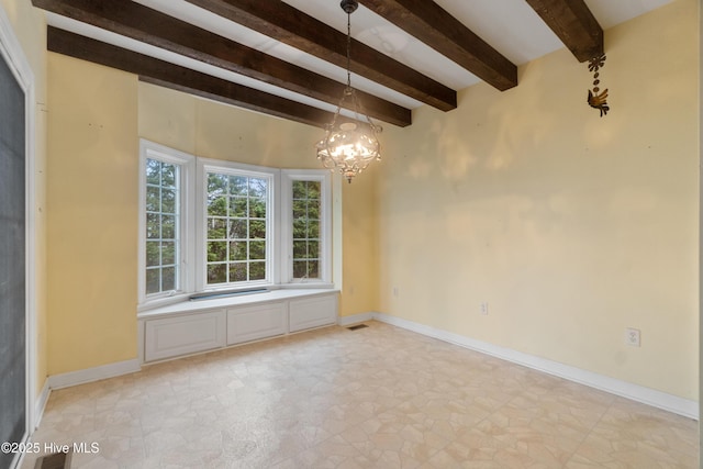 empty room featuring a chandelier and beamed ceiling