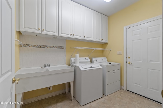 laundry room featuring cabinets and washing machine and dryer