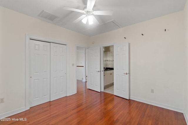 unfurnished bedroom with a closet, ceiling fan, and hardwood / wood-style floors