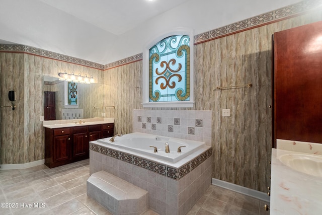 bathroom with vanity, tiled bath, and tile patterned floors