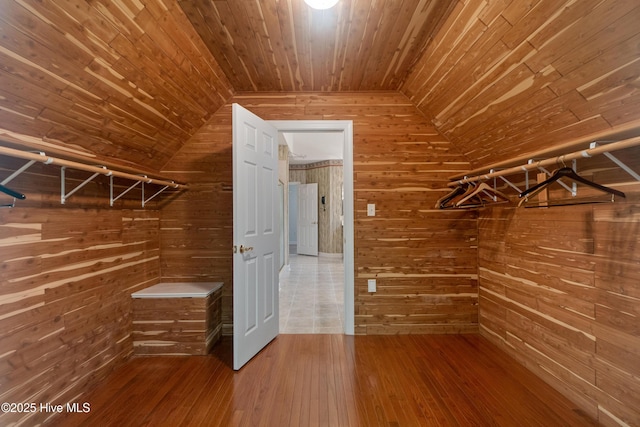 spacious closet with vaulted ceiling and hardwood / wood-style flooring