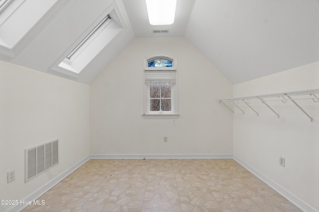 bonus room featuring vaulted ceiling with skylight