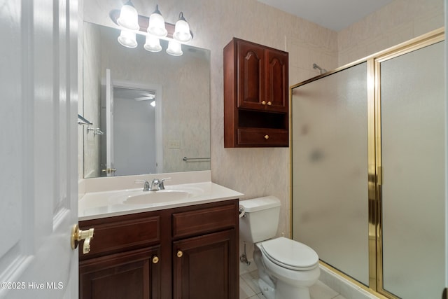 bathroom featuring vanity, an enclosed shower, and toilet