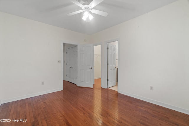 empty room with hardwood / wood-style flooring and ceiling fan