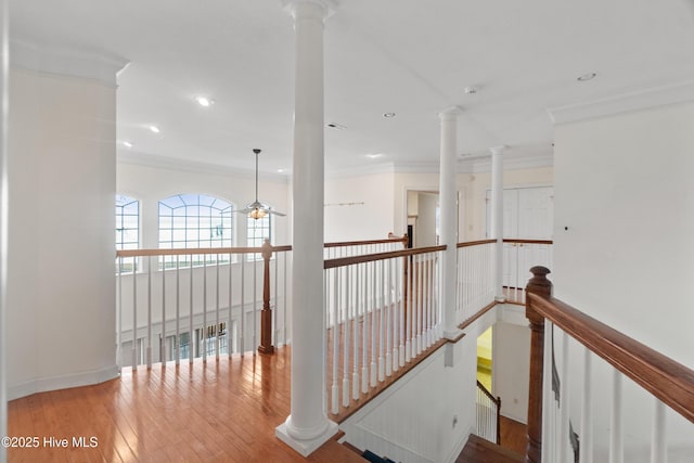 corridor with light wood-type flooring and ornamental molding