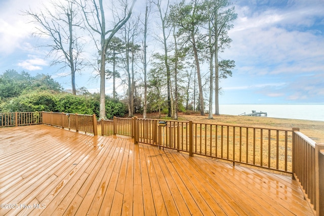 wooden deck featuring a water view