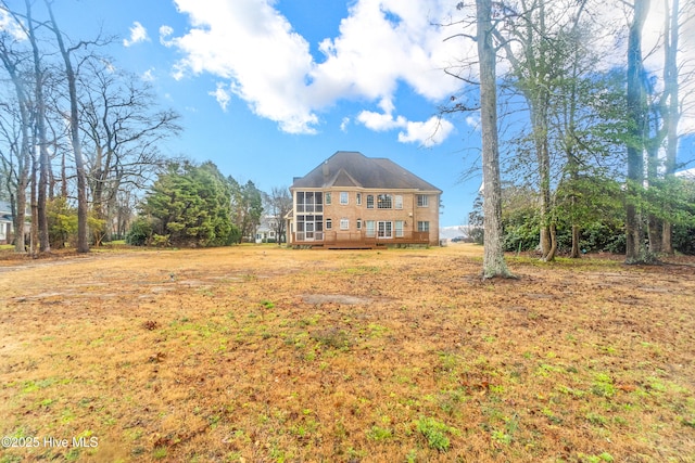 rear view of property featuring a wooden deck