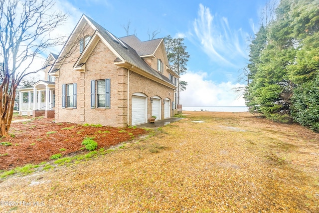 view of side of property featuring a yard and a garage