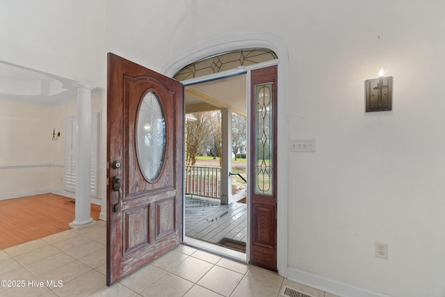 tiled entrance foyer featuring ornate columns