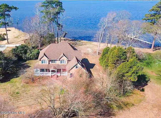 birds eye view of property with a water view