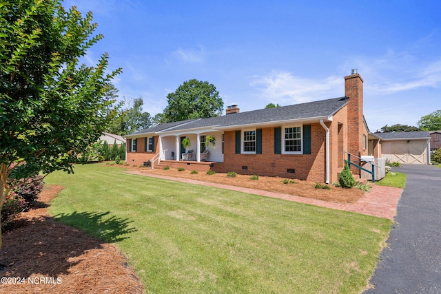 ranch-style house with a front yard and covered porch