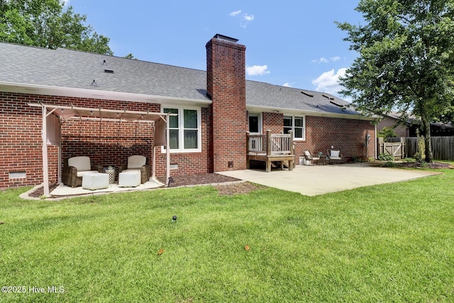 back of house featuring a patio area and a yard