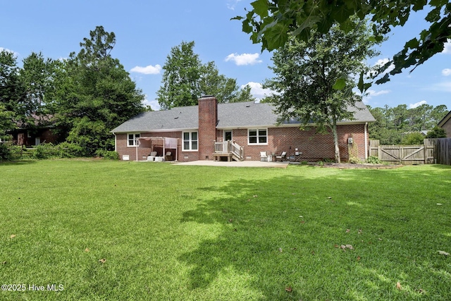 back of house featuring a patio area and a yard